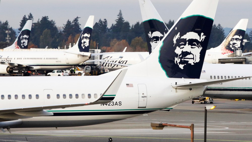 A ground crew member walks near Alaska Airlines planes parked at Seattle-Tacoma International Airport in SeaTac, Wash., Oct., 30, 2013. (Photo by Jason Redmond/Reuters)