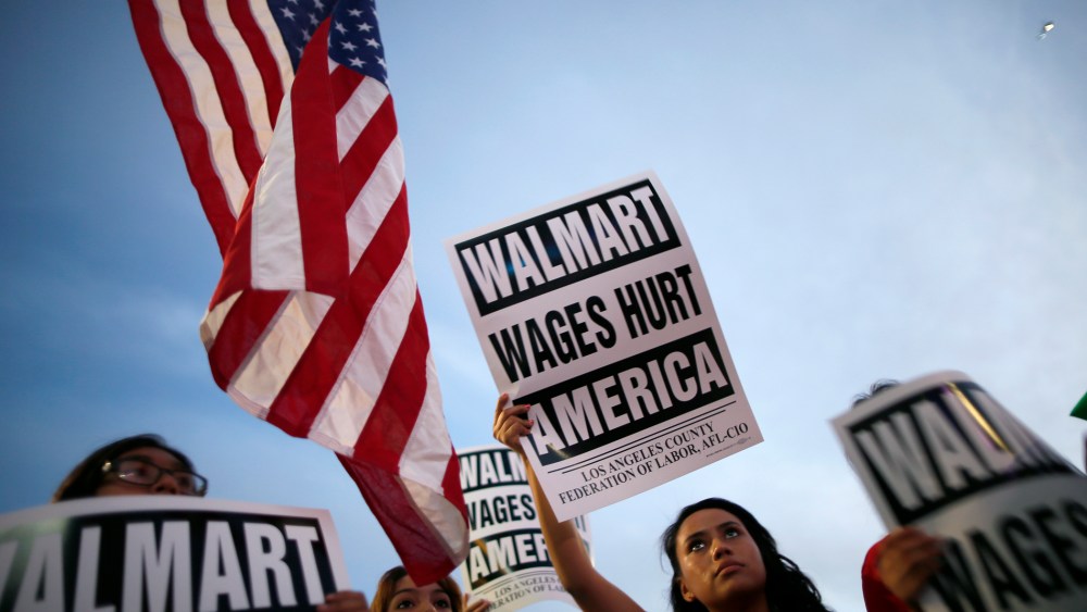 Karen Gariel (C), 15, takes part in a protest for better wages outside Walmart in Los Angeles on Nov. 7, 2013.