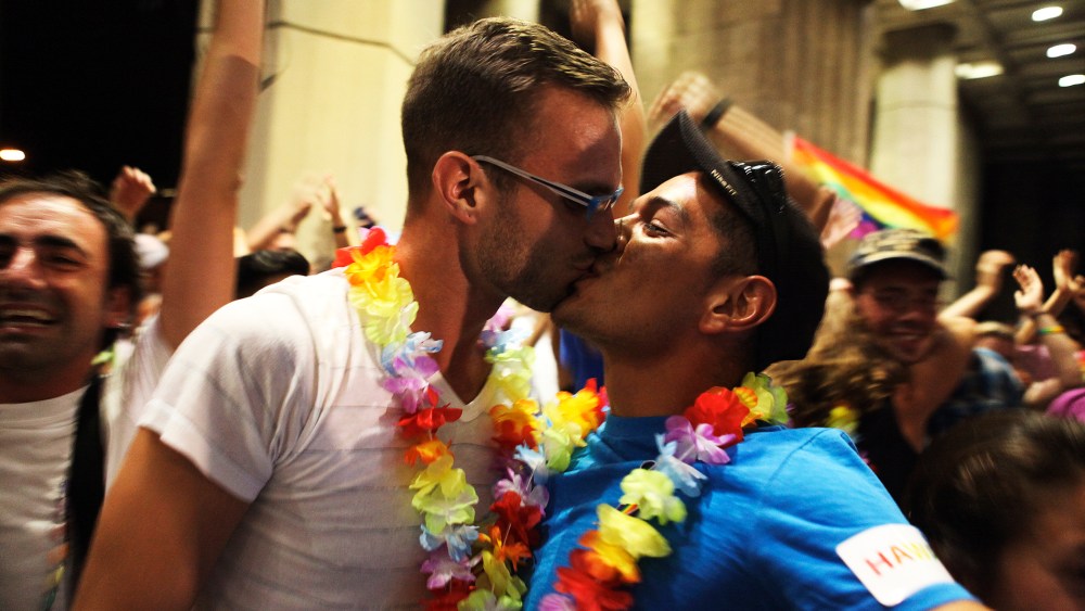 Jon Raffesberger and his partner German Sanchez celebrate after the Hawaii State Legislature voted on allowing same sex marriage in Honolulu, HI, November 8, 2013.