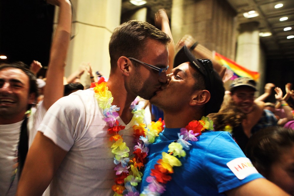 Jon Raffesberger and his partner German Sanchez celebrate after the Hawaii State Legislature voted on allowing same sex marriage in Honolulu, HI, November 8, 2013.