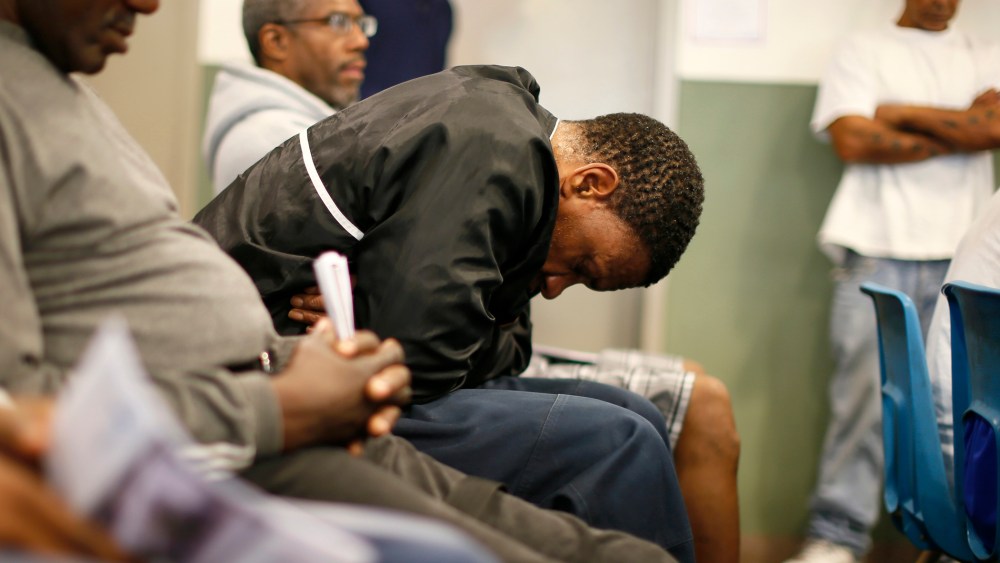 U.S. military veterans listen to speeches during a Veterans Day observance for homeless veterans at The Midnight Mission shelter in Los Angeles, Nov. 11, 2013.