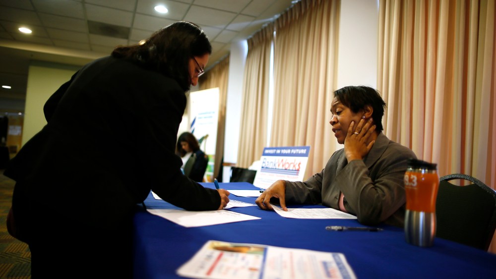 Alese Pedro, from JVS-BankWorks (R), talks to job seeker Gloria Cuellar, 38, at a job fair in Los Angeles, Calif. on Nov. 18, 2013.