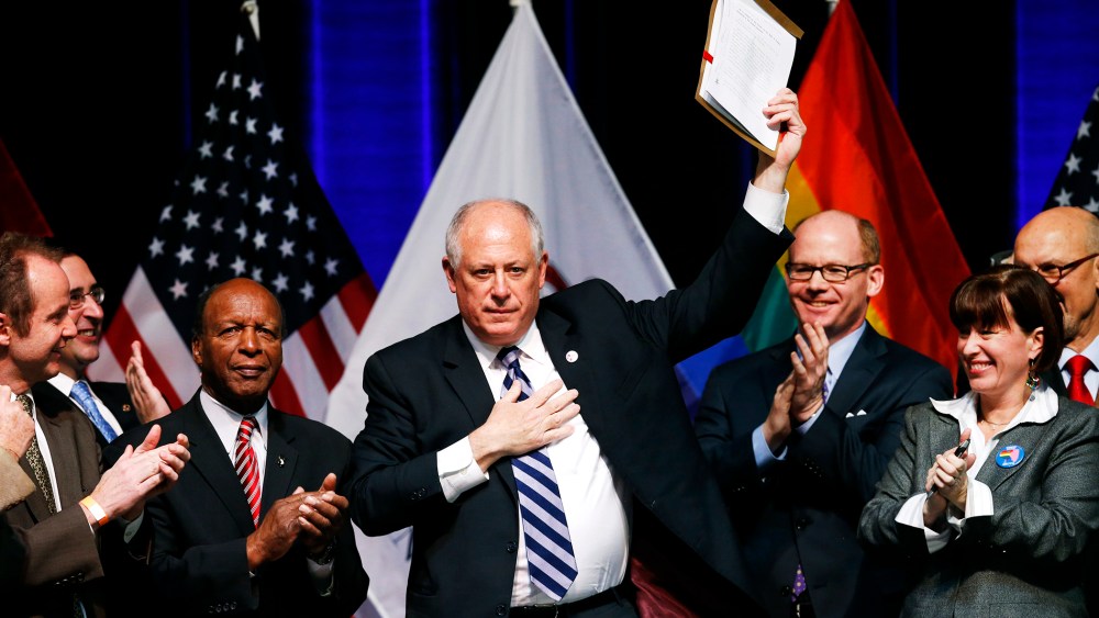 Illinois Governor Pat Quinn holds up the Religious Freedom and Marriage Fairness Act after signing it into law, Nov. 20, 2013.