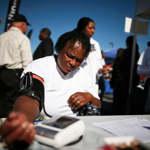 Bernita Jackson, 51, has her blood pressure measured at an event to inform people about the Affordable Care Act and donate turkeys to 5,000 needy families, in Los Angeles, Calif on Nov. 25, 2013.