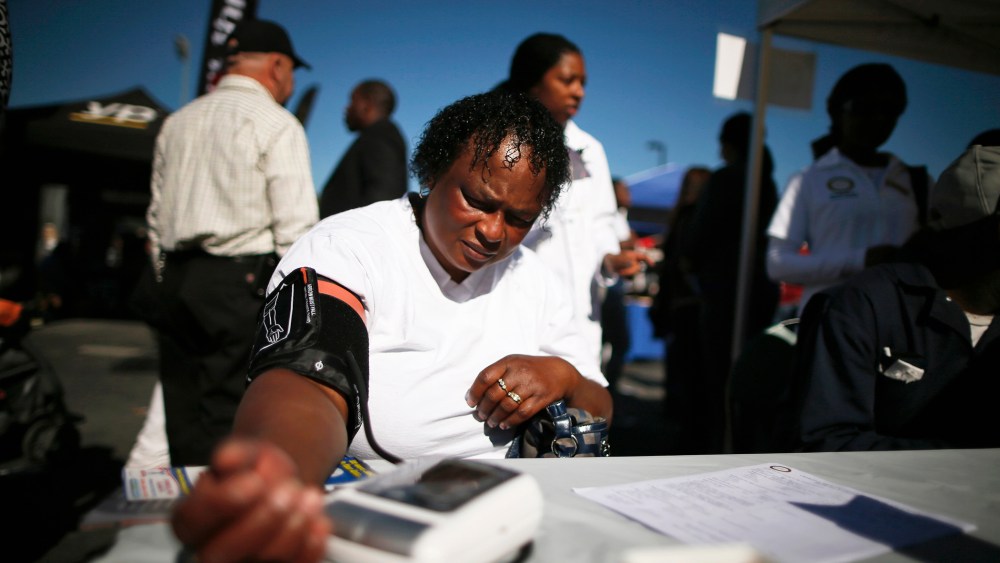Bernita Jackson, 51, has her blood pressure measured at an event to inform people about the Affordable Care Act and donate turkeys to 5,000 needy families, in Los Angeles, Calif on Nov. 25, 2013.