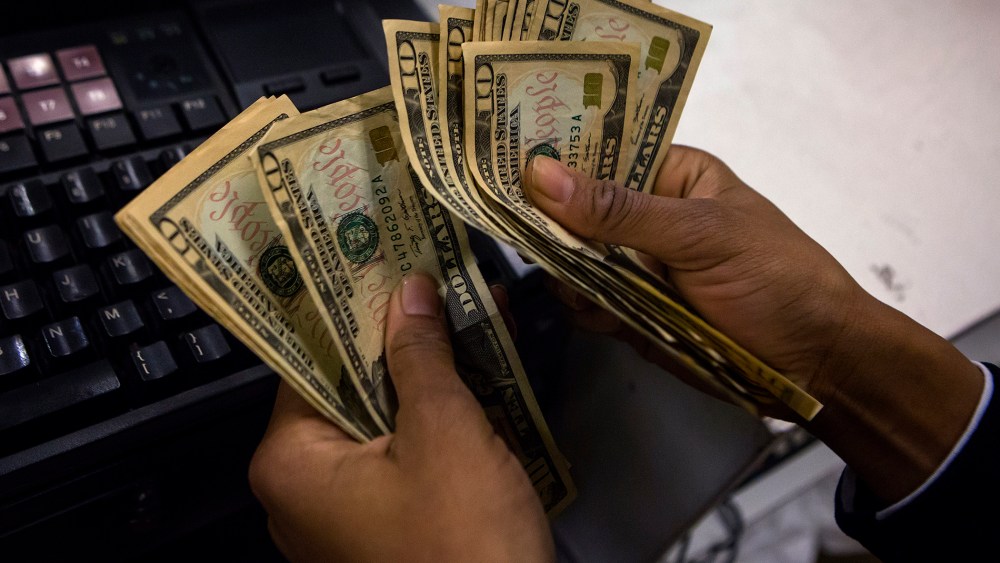 A cashier counts out money at Macy's Herald Square on Thanksgiving Day in New York, Nov. 28, 2013.