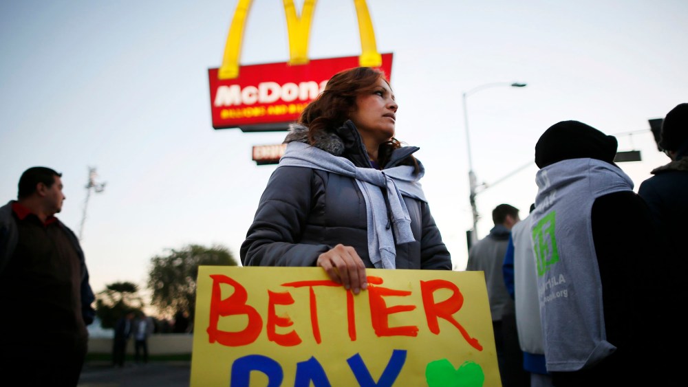 Protesters march outside McDonald's in Los Angeles, California, December 5, 2013.