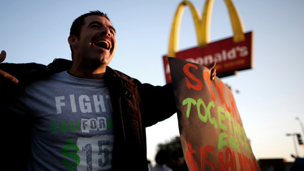 Striking McDonald's worker Abran Escarzaga, 31, protests outside McDonald's in Los Angeles