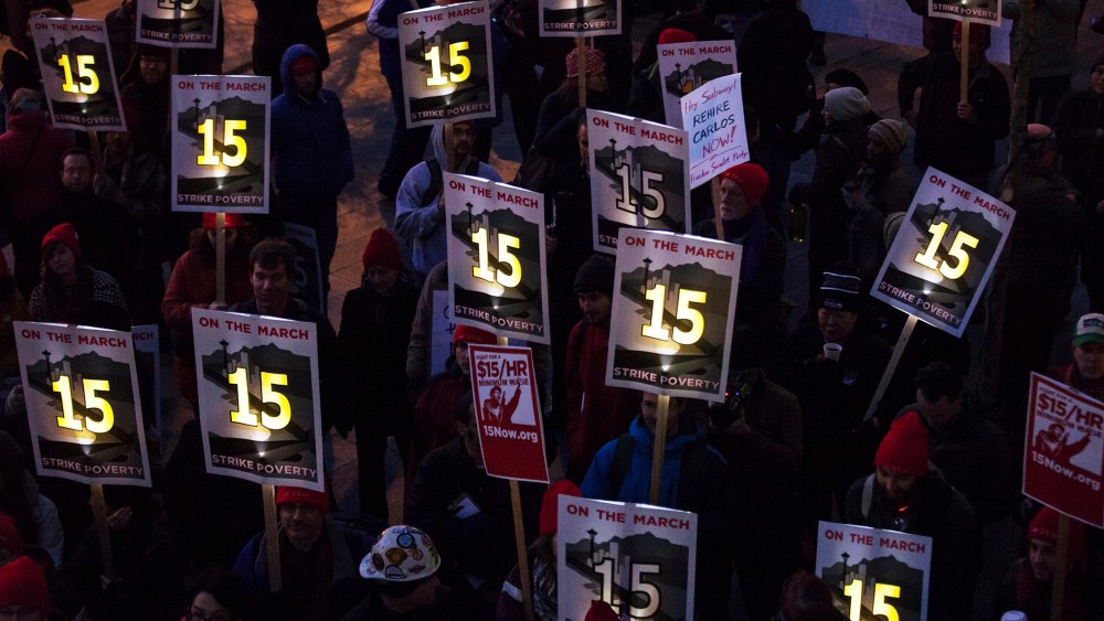 Demonstrators stage a rally to raise the hourly minimum wage to $15 for fast-food workers at City Hall in Seattle, Washington, Dec. 5, 2013.