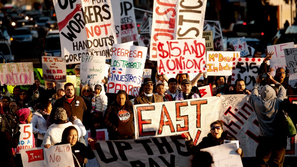 Demonstrators demanding an increase in worker wages march to a Jack in The Box fast food outlet in Oakland, California Dec. 5, 2013.