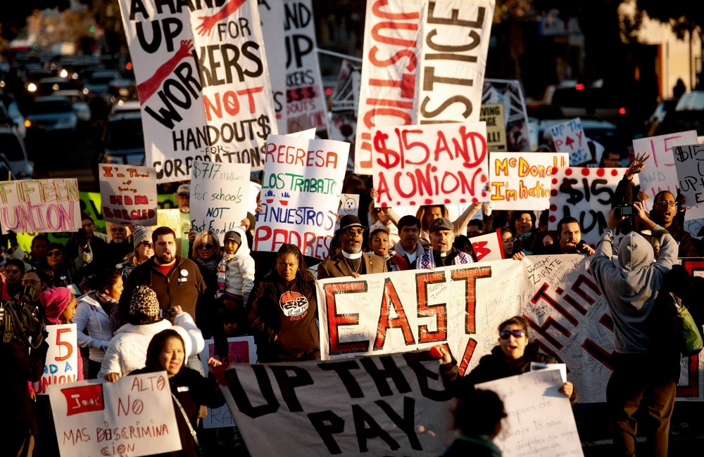 Demonstrators demanding an increase in worker wages march to a Jack in The Box fast food outlet in Oakland, California Dec. 5, 2013.