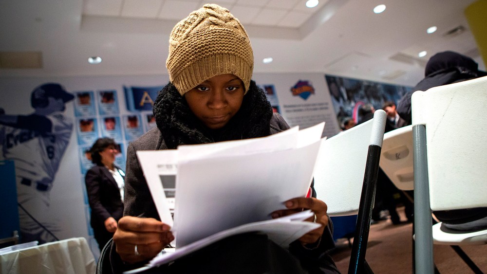 A woman fills out paperwork at a job training and resource fair at Coney Island in New York Dec. 11, 2013.
