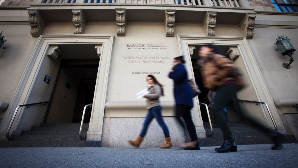 People walk past Baruch College in New York, Dec. 12, 2013. (Photo by Carlo Allegri/Reuters)