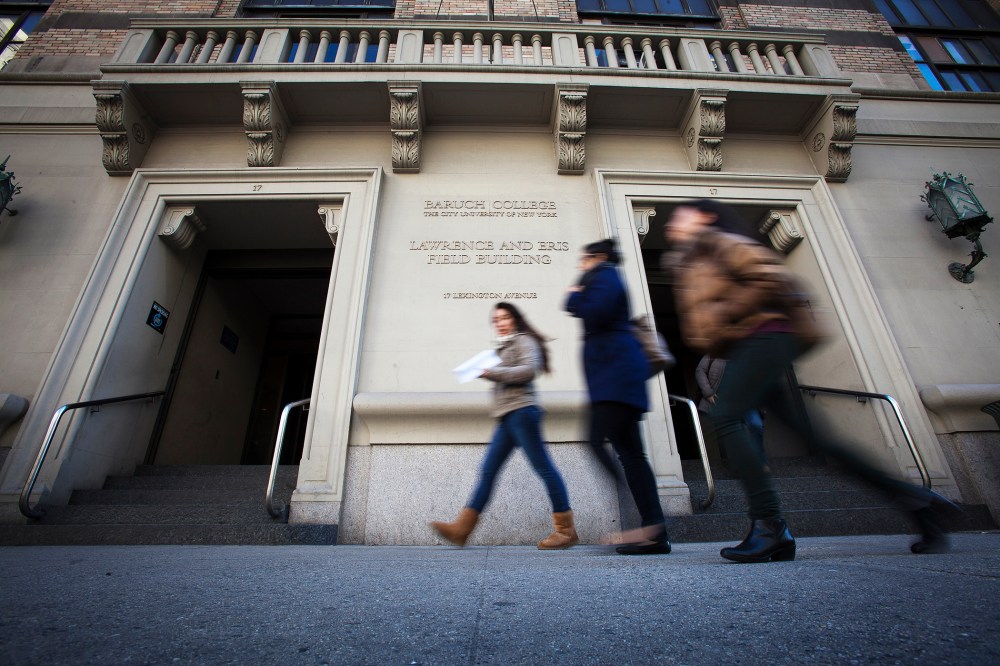 People walk past Baruch College in New York, Dec. 12, 2013. (Photo by Carlo Allegri/Reuters)