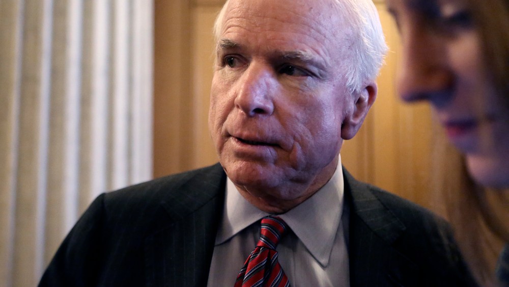U.S. Senator McCain talks to reporters after a Senate cloture vote on budget bill on Capitol Hill in Washington