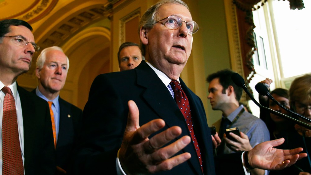 U.S. Senate Minority Leader Mitch McConnell (R-KY) speaks to the media following a Senate cloture vote on budget bill on Capitol Hill in Washington, Dec. 17, 2013.