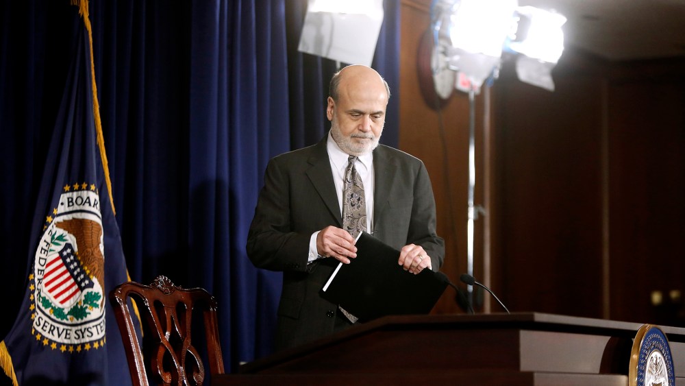 U.S. Federal Reserve Chairman Ben Bernanke takes his seat for a news conference at the Federal Reserve Bank headquarters in Washington, Dec. 18, 2013.