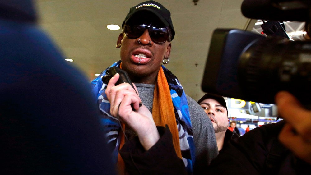 Former NBA basketball player Dennis Rodman talks to the media at the Beijing International Airport in Beijing, Dec. 19, 2013 before leaving for Pyongyang, North Korea.
