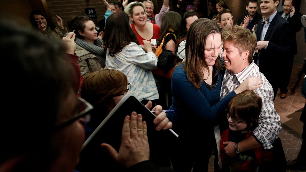 Kim Hackford-Peer marries her partner Ruth Hackford-Peer as Ruth holds their son Casey, 7, at the Salt Lake County office building in Salt Lake City, Utah