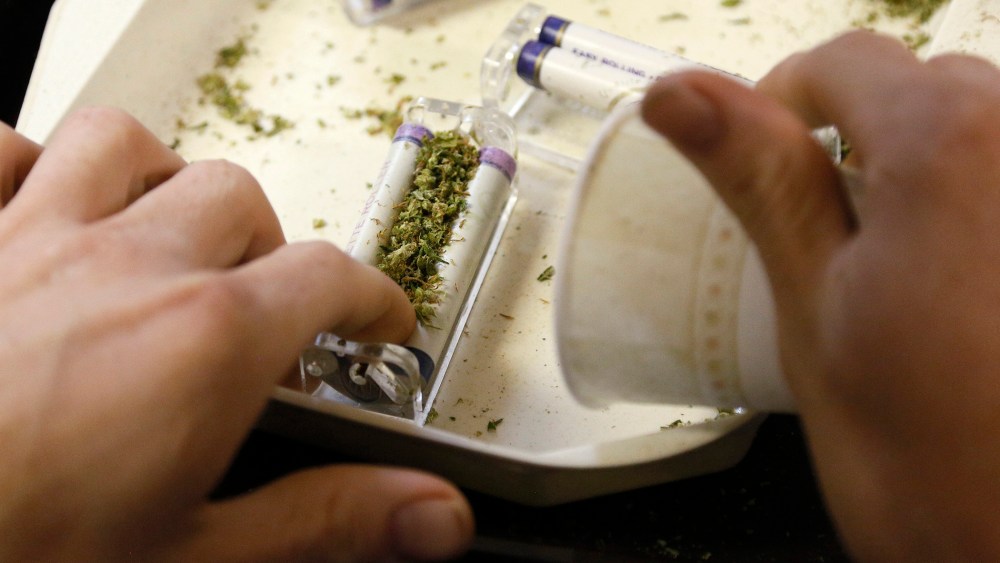 A worker rolls marijuana joints for sale at the Botanacare marijuana store ahead of their grand opening on New Year's day in Northglenn, Colo. Dec. 31, 2013.