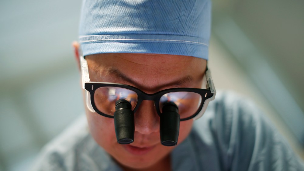 Doctor Andy Chiou operates on a patient in Peoria, Ill., Nov. 26, 2013.