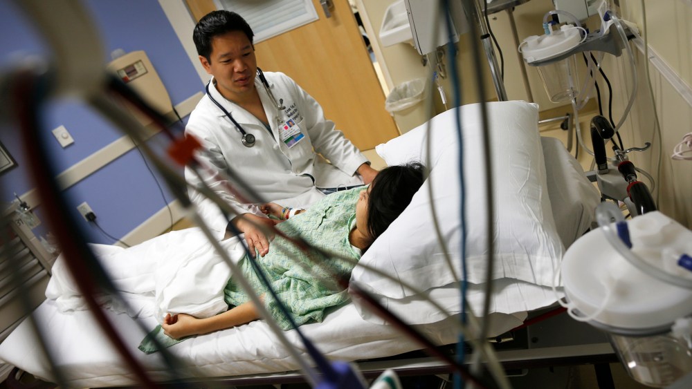 A patient speaks with Doctor Leon Yeh in the Emergency Room at OSF Saint Francis Medical Center in Peoria, Illinois, Nov. 26, 2013.