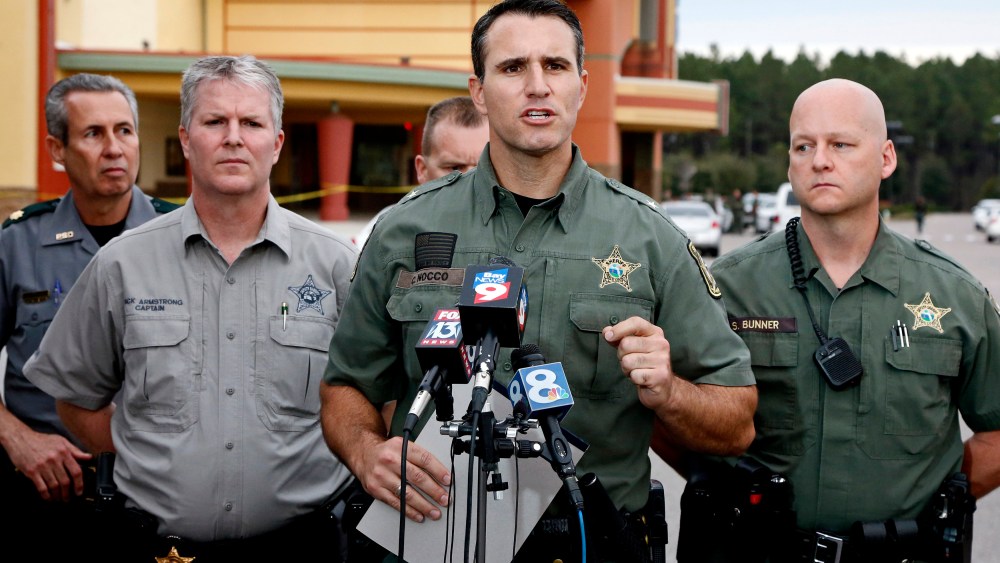 Pasco County Sheriff Chris Nocco (C) speaks to the media as police tape surrounds the Cobb Grove 16 movie theater, where a moviegoer shot and killed one person and wounded another, in Wesley Chapel, Fl., Jan. 13, 2014. (Photo by Mike Carlson/Reuters)