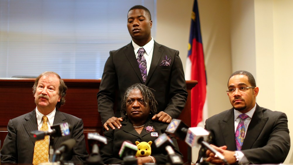 Attorney Charles Monnett (L) speaks regarding Jonathan Ferrell, who was shot and killed in September 2013, as mother Georgia Ferrell (C) look on during a news conference in Charlotte, N.C. Jan. 14, 2014.