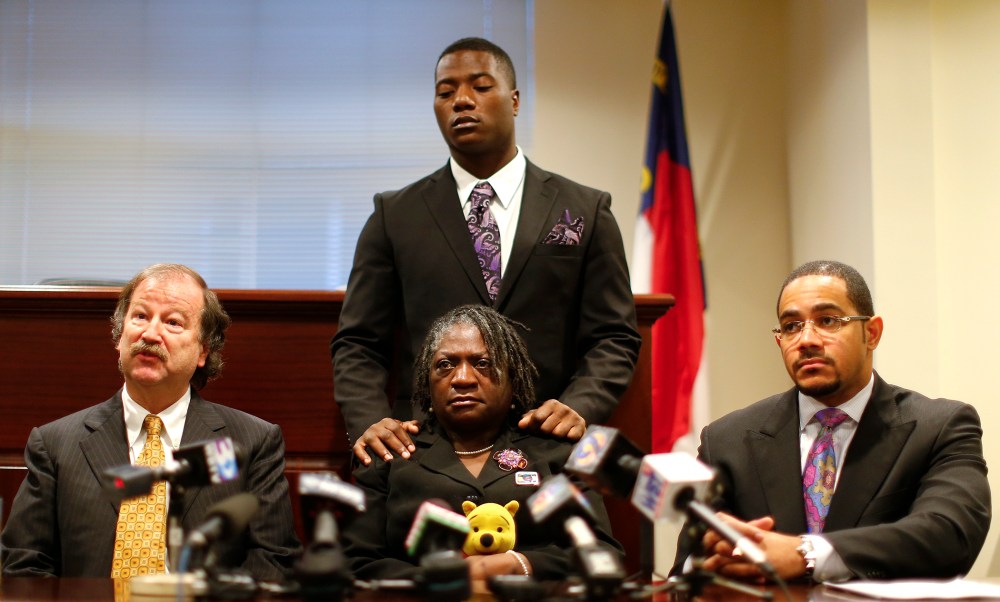 Attorney Charles Monnett (L) speaks regarding Jonathan Ferrell, who was shot and killed in September 2013, as mother Georgia Ferrell (C) look on during a news conference in Charlotte, N.C. Jan. 14, 2014.
