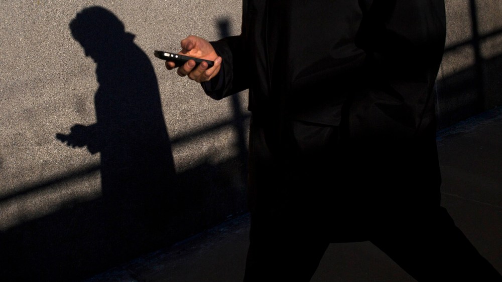 A commuter uses his mobile phone in New York