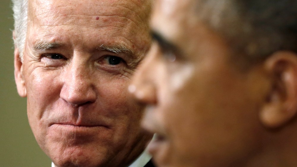 U.S. Vice President Joe Biden (L) listens as President Barack Obama speaks at the White House in Washington on Jan. 22, 2014.