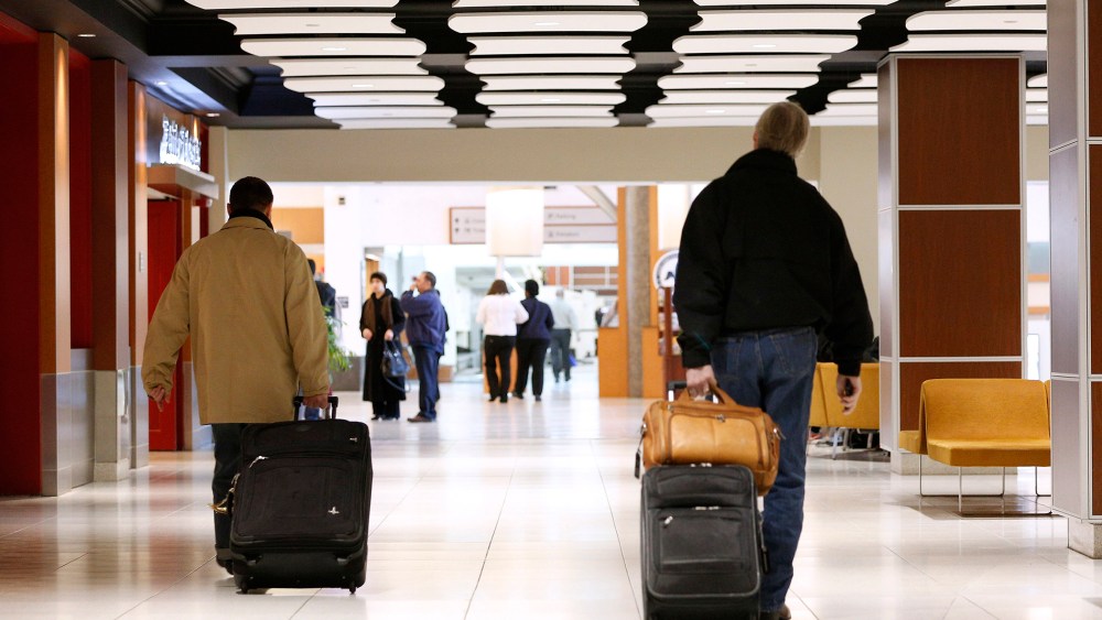 Passengers walk through the terminals of Louis Armstrong International Airport in Kenner, La. on Jan. 29, 2014.