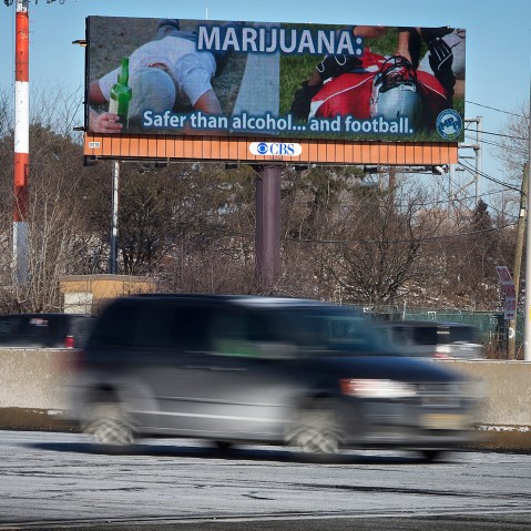 Cars drive past a billboard alongside a highway in Newark, New Jersey, Jan. 29, 2014.