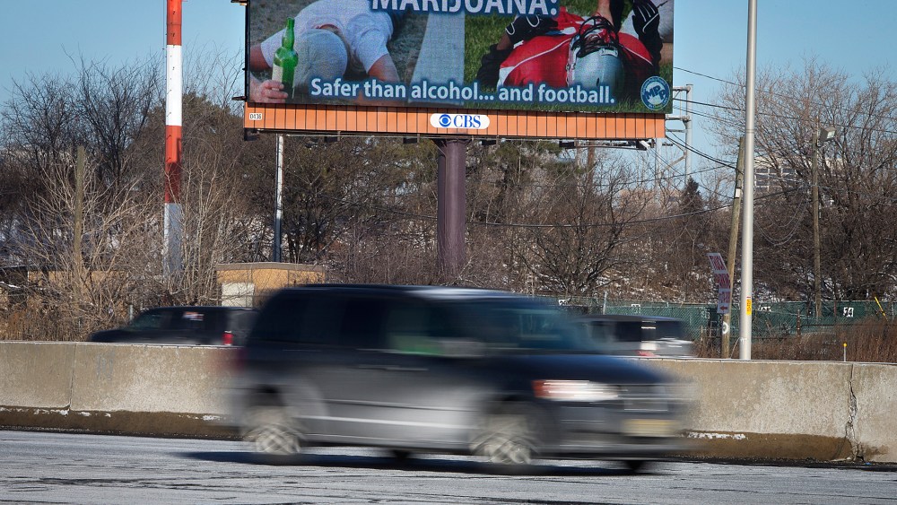 Cars drive past a billboard alongside a highway in Newark, New Jersey, Jan. 29, 2014.