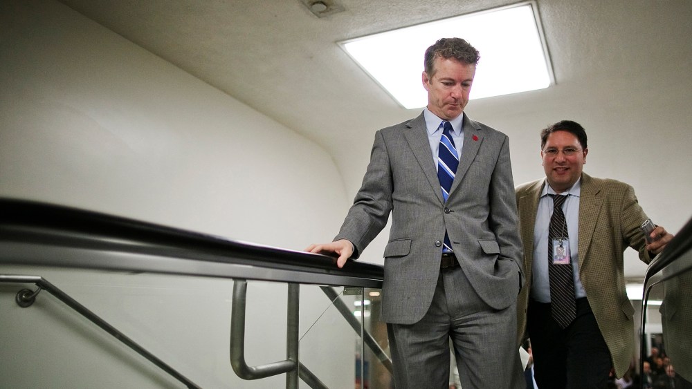 U.S. Senator Rand Paul talks to a reporter as he arrives for the weekly Republican caucus luncheon at the U.S. Capitol, Feb. 4, 2014.
