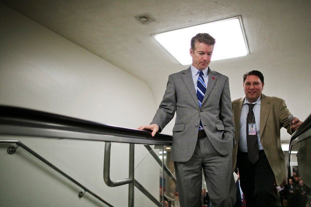 U.S. Senator Rand Paul talks to a reporter as he arrives for the weekly Republican caucus luncheon at the U.S. Capitol, Feb. 4, 2014.