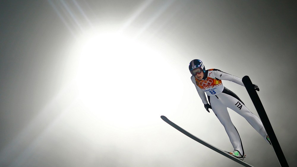 Italy's Evelyn Insam soars through the air in her trial jump during the women's ski jumping individual normal hill event of the Sochi 2014 Winter Olympic Games, at the RusSki Gorki Ski Jumping Center in Rosa Khutor, February 11, 2014.