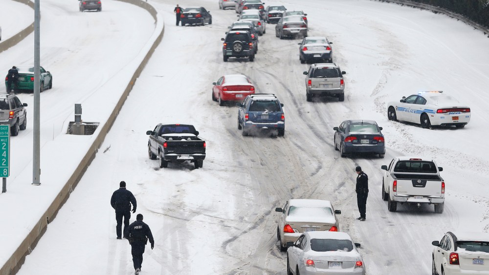 Police Officers work to assist motorists in Charlotte, North Carolina, Feb. 12, 2014.