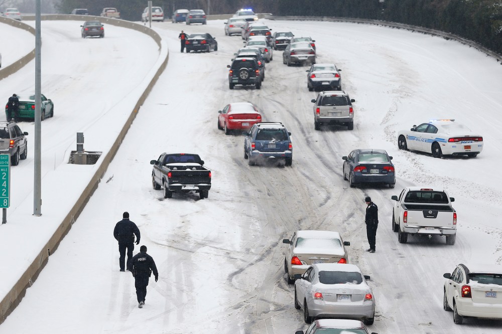 Police Officers work to assist motorists in Charlotte, North Carolina, Feb. 12, 2014.