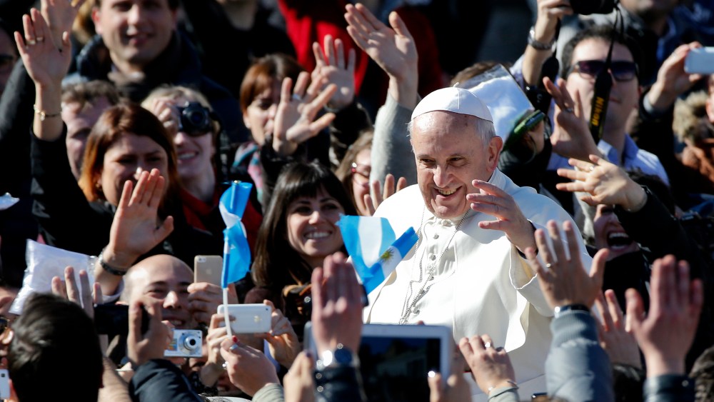 Pope Francis leaves at the end of a special audience with engaged couple, to celebrate Saint Valentine's day, in Saint Peter's square at the Vatican on Feb. 14, 2014.