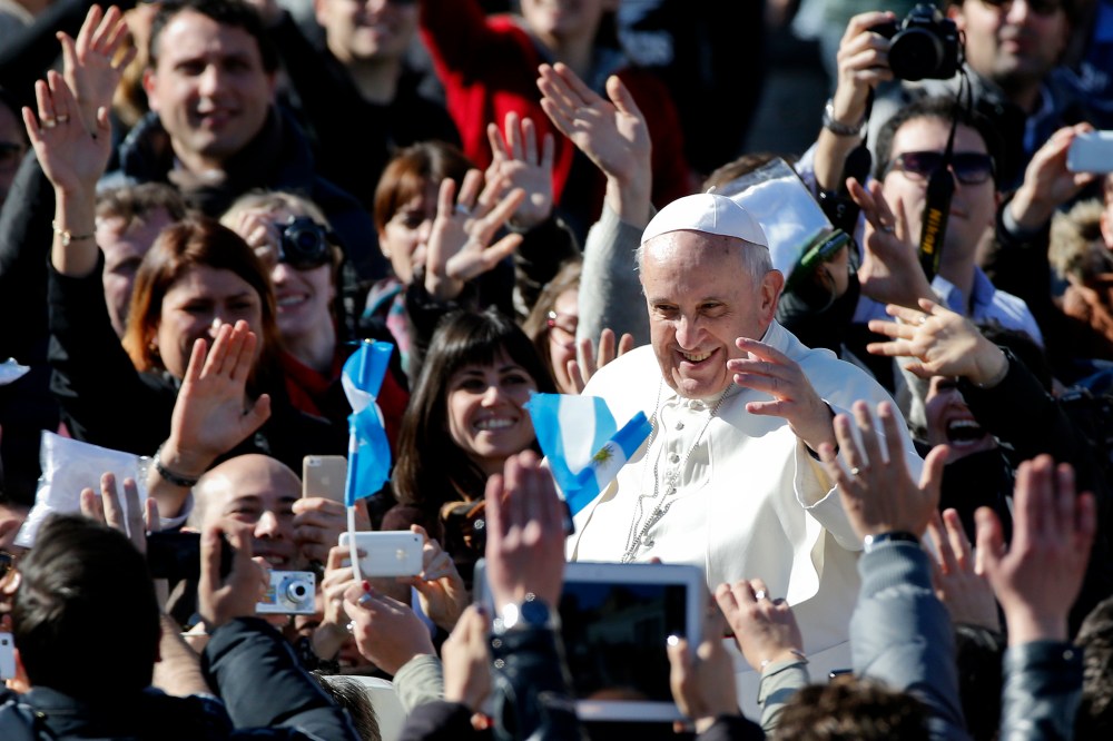 Pope Francis leaves at the end of a special audience with engaged couple, to celebrate Saint Valentine's day, in Saint Peter's square at the Vatican on Feb. 14, 2014.