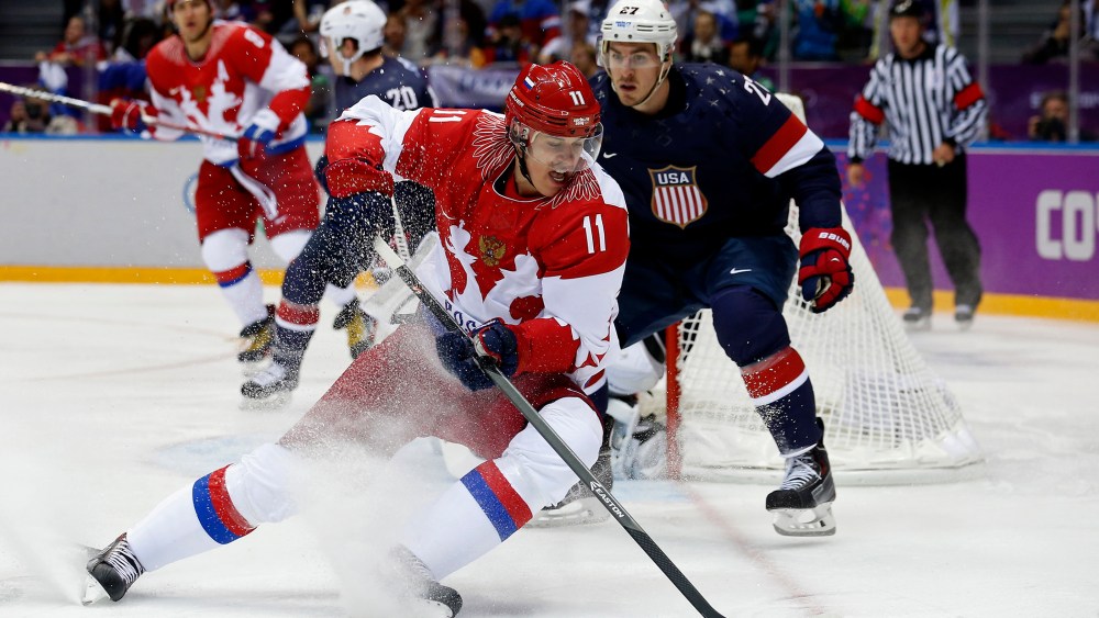 Russia's Yevgeni Malkin (L) spins away from Team USA's Ryan McDonagh during the first period of their men's preliminary round ice hockey game, Feb. 15, 2014, in Sochi, Russia.