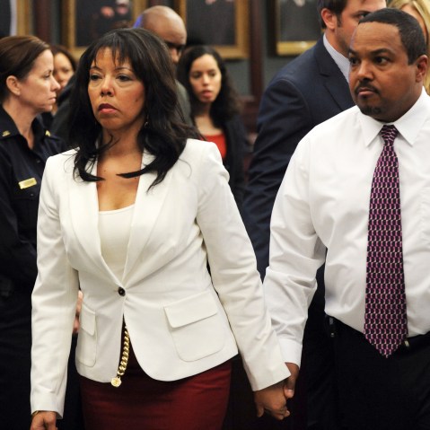 Jordan Davis' mother, Lucia McBath (C) leaves the courtroom with her husband Curtis McBath (R) as court recessed for the jury to reconsider the first charge against Michael Dunn in Jacksonville, Fla., Feb. 15, 2014.