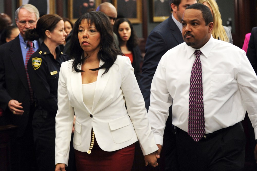 Jordan Davis' mother, Lucia McBath (C) leaves the courtroom with her husband Curtis McBath (R) as court recessed for the jury to reconsider the first charge against Michael Dunn in Jacksonville, Fla., Feb. 15, 2014.
