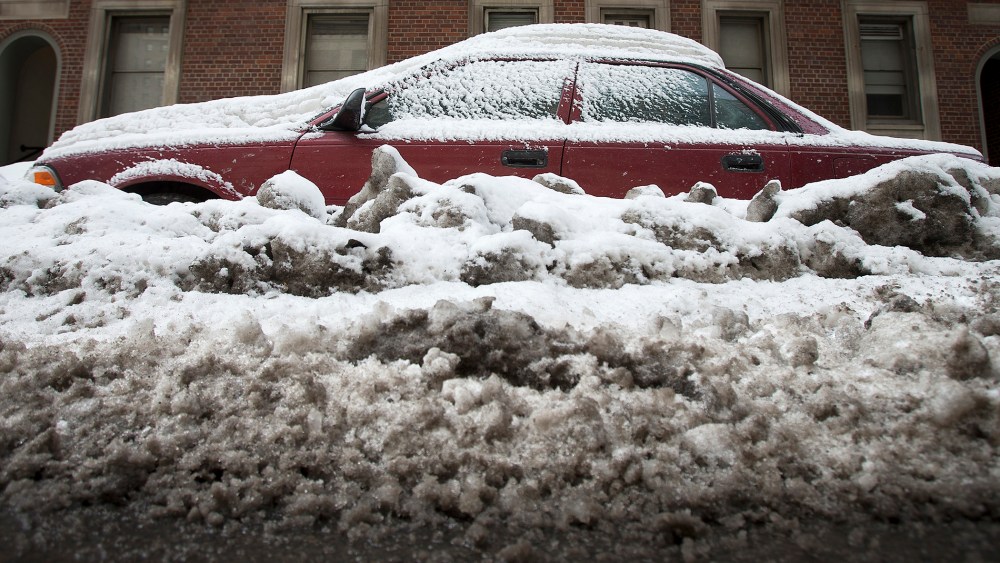 A car that is completely inundated by snow and ice that have accumulated from recent storms is pictured in the Manhattan borough of New York on Feb.16, 2014.