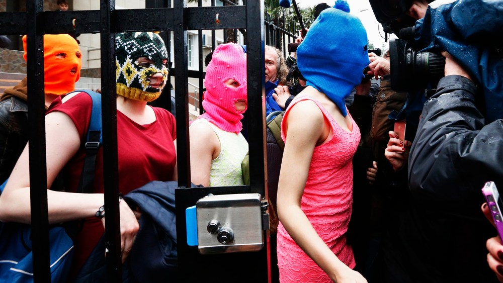Masked members of Pussy Riot leave a police station in Adler during the 2014 Sochi Winter Olympics, Feb. 18, 2014.