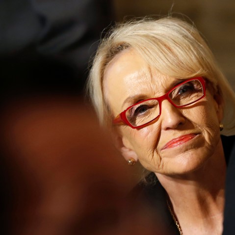 Arizona Governor Jan Brewer watches as U.S. President Barack Obama addresses the National Governors Association, Feb. 24, 2014.