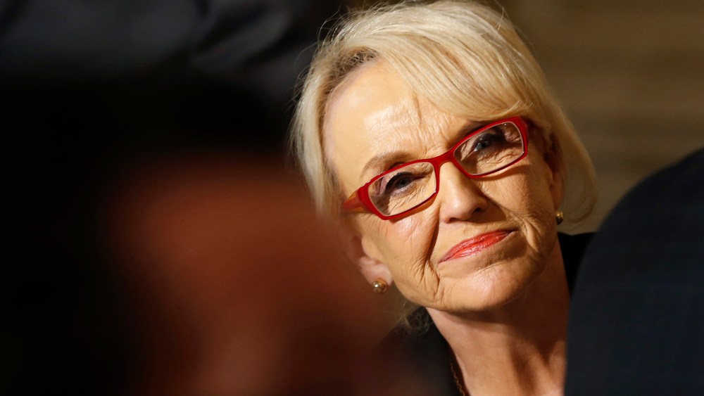 Arizona Governor Jan Brewer watches as U.S. President Barack Obama addresses the National Governors Association, Feb. 24, 2014.