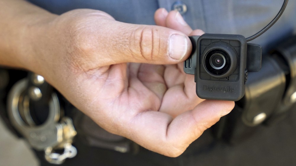 A Colorado Springs police officer poses with a Digital Ally First Vu HD body worn camera outside the police department in Colorado Springs April 21, 2015. (Photo by Rick Wilking/Reuters)