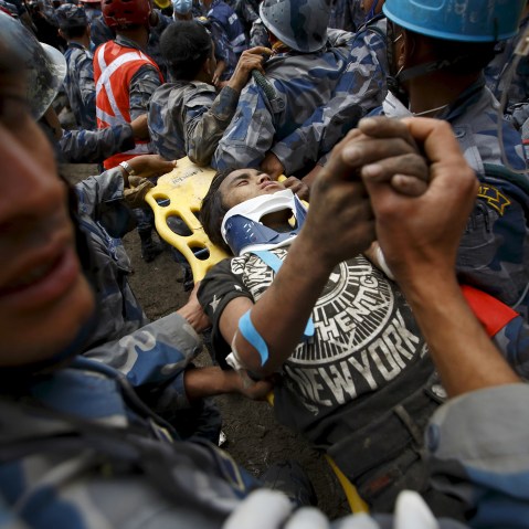 A teenage earthquake survivor is rescued by the Armed Police Force from the collapsed Hilton Hotel, the result of an earthquake in Kathmandu, Nepal on April 30, 2015.